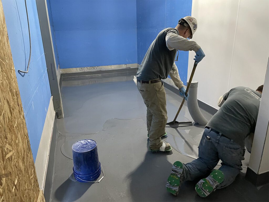 spreading urethane cement with a cam rake in Castle Rock restaurant kitchen