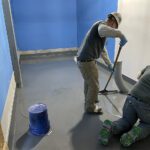 spreading urethane cement with a cam rake in Castle Rock restaurant kitchen