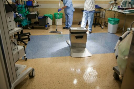 Medical staff cleaning a hospital room