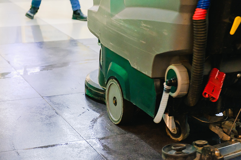 Driving an autoscrubber cleaning floors