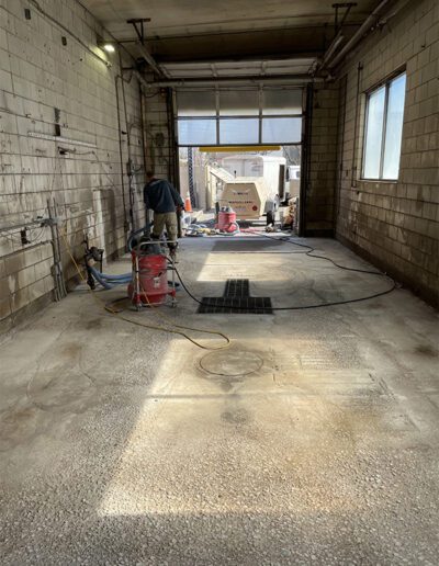 prepping concrete surface for resinous flooring in carwash