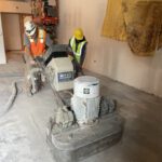 pushing a large concrete grinder