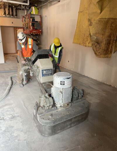 pushing a large concrete grinder