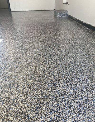 Blue black white flake epoxy floor in residential garage