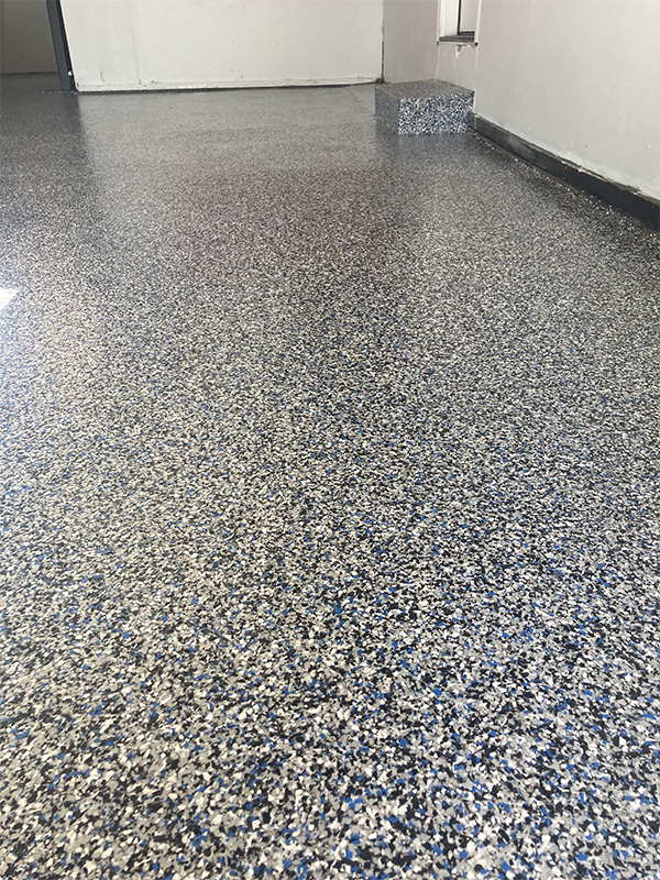 Blue black white flake epoxy floor in residential garage